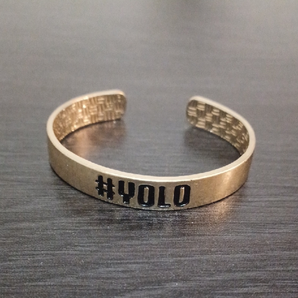 Worn Gold Cuff Bracelet with #YOLO Engraving